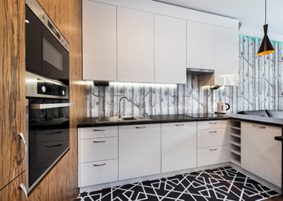 aspen tree design wallpaper installed behind cabinets in kitchen